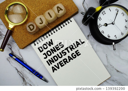 DJIA Dow Jones Industrial Average text written on notepad with calculator and magnifying glass on marble background DJIA Dow Jones Industrial Average text written on notepad with calculator and magnifying glass on marble background 139392200