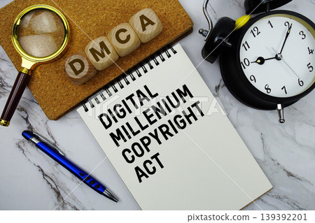 DMCA Digital Millennium Copyright Act text written on notepad with calculator and magnifying glass on marble background 139392201