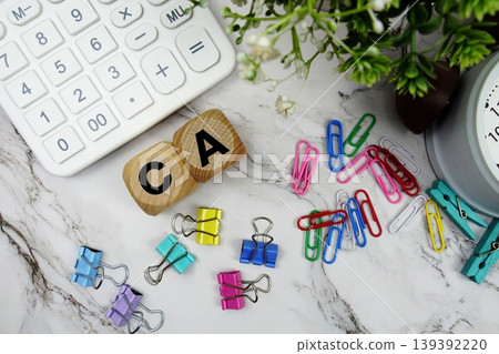 CA (Current Account) alphabet letters with calculator and alarm clock on marble background CA (Current Account) alphabet letters with calculator and alarm clock on marble background 139392220