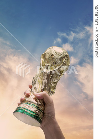 Bangkok Thailand. May 4 2026. Mock Up of the FIFA World Cup Trophy in hand and sky Background. Man holding a trophy of the FIFA World Cup in hand. Fifa 2026 winning trophy is raised up in the air. Bangkok Thailand. May 4 2026. Mock Up of the FIFA World Cup Trophy in hand and sky Background. Man holding a trophy of the FIFA World Cup in hand. Fifa 2026 winning trophy is raised up in the air. 139393306