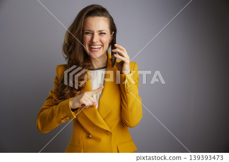 Businesswoman Pointing Forward on Phone Call Businesswoman Pointing Forward on Phone Call 139393473