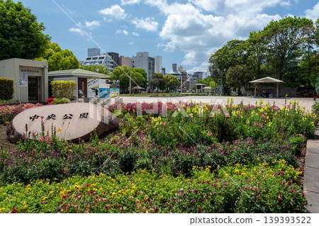 A stone sign, flowerbeds, and streetscape of Tenmonkan in Kagoshima City Central Park (Tenpark) (Spring scenery - copy space available) A stone sign, flowerbeds, and streetscape of Tenmonkan in Kagoshima City Central Park (Tenpark) (Spring scenery - copy space available) 139393522