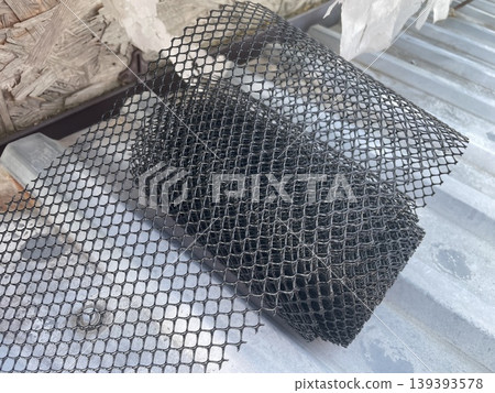 Installing leaf guard mesh in gutter Installing leaf guard mesh in gutter 139393578