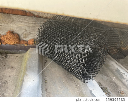 Installing leaf guard mesh in gutter Installing leaf guard mesh in gutter 139393583