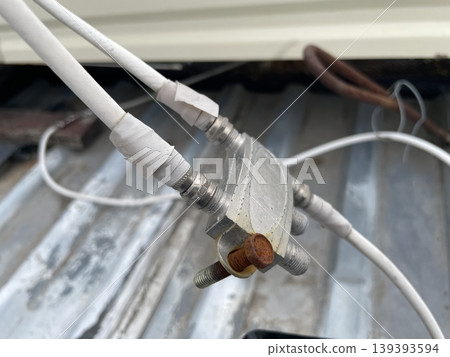 Adjusting satellite dish signal on rooftop Adjusting satellite dish signal on rooftop 139393594