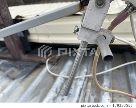 Adjusting satellite dish signal on rooftop 139393595