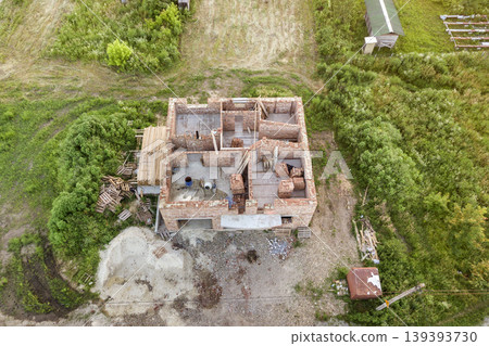 Aerial view of building site for future house, brick basement floor and stacks of brick for construction. Aerial view of building site for future house, brick basement floor and stacks of brick for construction. 139393730