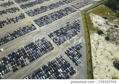 Aerial view of auction reseller company big parking lot with parked cars ready for remarketing services. Sales of secondhand vehicles Aerial view of auction reseller company big parking lot with parked cars ready for remarketing services. Sales of secondhand vehicles 139393748