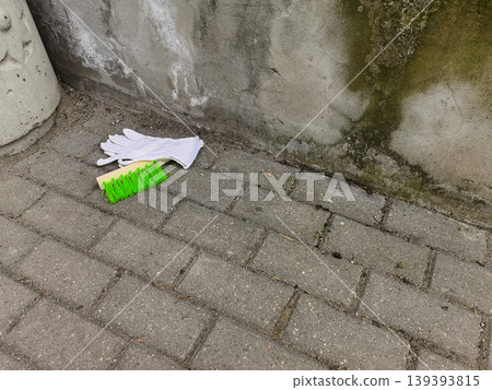Scrubbing Brush and White Gloves on Paving Stones Scrubbing Brush and White Gloves on Paving Stones 139393815