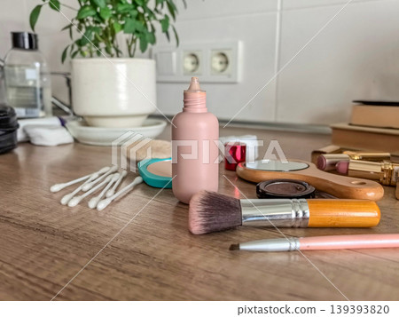 Makeup essentials on a wooden dressing table Makeup essentials on a wooden dressing table 139393820