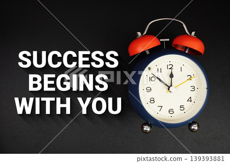Success Begins With You text with alarm clock on black background Success Begins With You text with alarm clock on black background 139393881