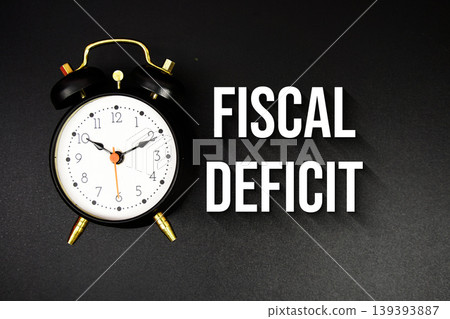 Fiscal Deficit text with alarm clock on black background Fiscal Deficit text with alarm clock on black background 139393887