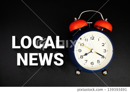 Local News text with alarm clock on black background Local News text with alarm clock on black background 139393891