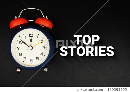 Top Stories text with alarm clock on black background 139393895
