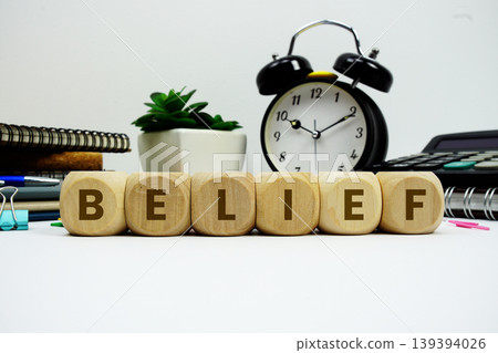 BELIEF alphabet letters with alarm clock and calculator on white background 139394026