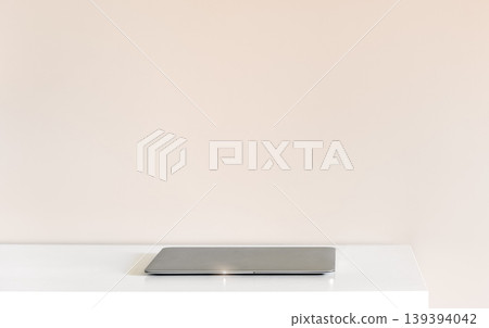 Closed laptop on white desk with copy space, minimal workspace background Closed laptop on white desk with copy space, minimal workspace background 139394042