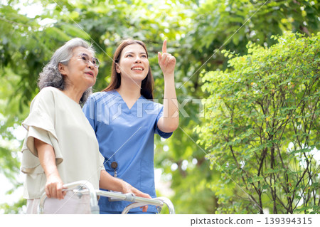 Asian female caregiver assistance senior patient with walker for physical rehabilitation and therapy Asian female caregiver assistance senior patient with walker for physical rehabilitation and therapy 139394315