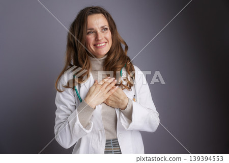 Compassionate Female Doctor with Hands on Chest Compassionate Female Doctor with Hands on Chest 139394553