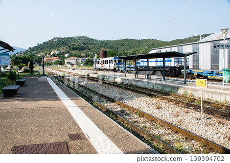 The railway tracks and platform of Ponte Lucia station nestled in the mountains, on the French island of Corsica in the Mediterranean Sea. The railway tracks and platform of Ponte Lucia station nestled in the mountains, on the French island of Corsica in the Mediterranean Sea. 139394702