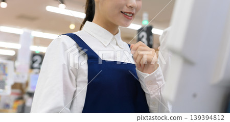 Female clerk working in a supermarket 139394812