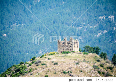 A ruined historical stone castle built atop a rocky mountain on the French island of Corsica in the Mediterranean Sea. A ruined historical stone castle built atop a rocky mountain on the French island of Corsica in the Mediterranean Sea. 139394888