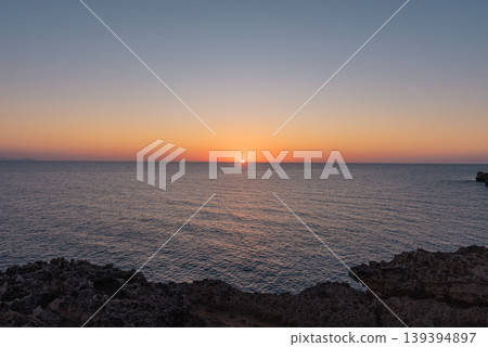 The peaceful sea at dawn or dusk, with serene and calm waters. The peaceful sea at dawn or dusk, with serene and calm waters. 139394897