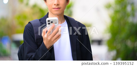 A man operating a smartphone 139395152