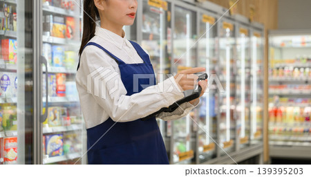Female clerk working in a supermarket 139395203