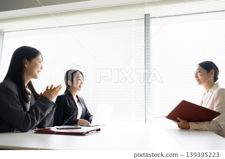 Japanese women having a meeting in the office Japanese women having a meeting in the office 139395223