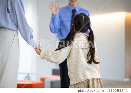 A Japanese girl waving to a security guard A Japanese girl waving to a security guard 139395241