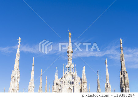 Virgin Mary golden statue and marble spiers and statues of Milan Cathedral 139395294
