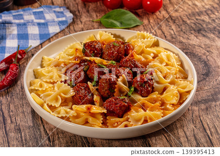 Delicious farfalle pasta with meatballs and tomato sauce Delicious farfalle pasta with meatballs and tomato sauce 139395413