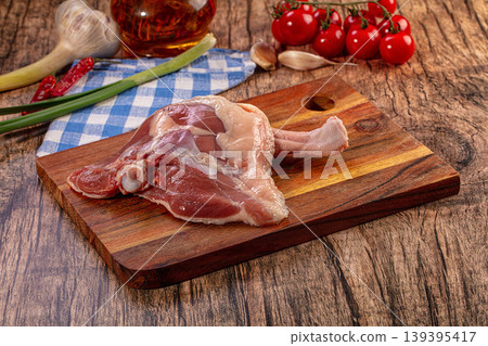 Raw Duck Leg, Cherry Tomatoes, Garlic, Green Onions, Chili Peppers on Rustic Wooden Board Raw Duck Leg, Cherry Tomatoes, Garlic, Green Onions, Chili Peppers on Rustic Wooden Board 139395417