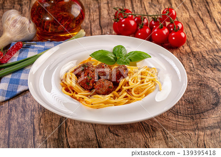 Spaghetti with meatballs and fresh basil, classic Italian pasta dish on rustic wooden table Spaghetti with meatballs and fresh basil, classic Italian pasta dish on rustic wooden table 139395418
