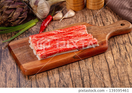 Imitation Crab Sticks on Wooden Cutting Board with Fresh Vegetables Imitation Crab Sticks on Wooden Cutting Board with Fresh Vegetables 139395461