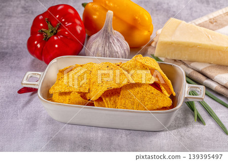 Corn nachos in ceramic bowl with fresh bell peppers, garlic, and cheese Corn nachos in ceramic bowl with fresh bell peppers, garlic, and cheese 139395497