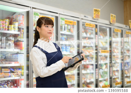 Female clerk working in a supermarket Female clerk working in a supermarket 139395588