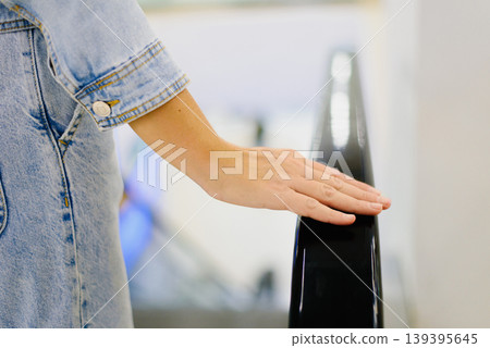 Customer Hand on Escalator Railing in Mall Customer Hand on Escalator Railing in Mall 139395645