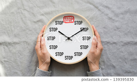 Female Hands Holding Clock with STOP Text Bad Habit Control Concept 139395830