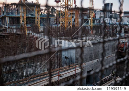 Urban construction site with cranes and building foundation city development concept Urban construction site with cranes and building foundation city development concept 139395849