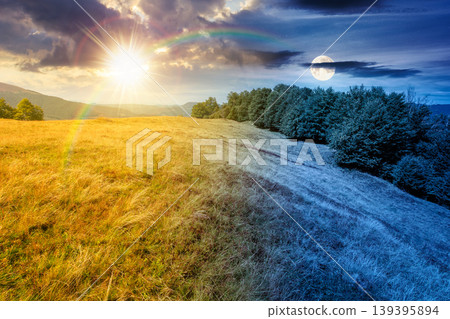day meet night above carpathian mountain field. view of countryside landscape with valley behind the forest on the hill. sun and moon over clouds on a sky. autumn equinox background for astrology day meet night above carpathian mountain field. view of countryside landscape with valley behind the forest on the hill. sun and moon over clouds on a sky. autumn equinox background for astrology 139395894