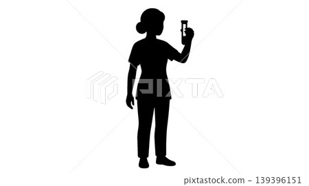 Silhouette of a medical professional inspecting a test tube. 139396151