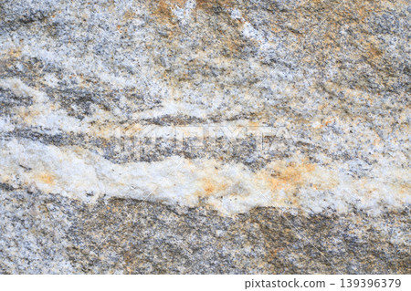 Rough grey granite texture with white and brown mineral veins. Natural stone surface for architectural design, 139396379