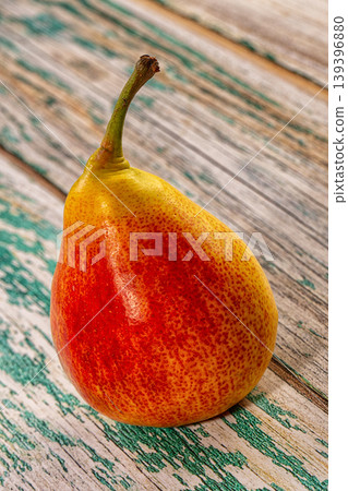 Vibrant red and yellow pear on rustic wooden table, healthy fresh fruit still life 139396880