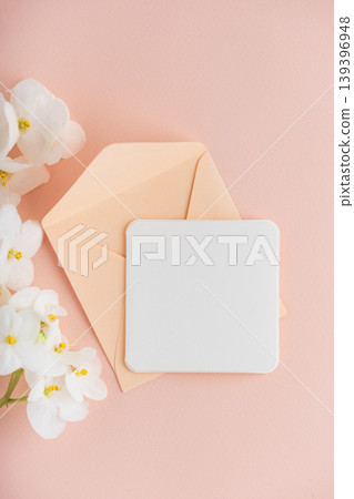 Pink Envelope with White Flowers and Card on Pink Background 139396948