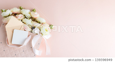 Pink Gift Bag with Flowers and Card on Pink Background Pink Gift Bag with Flowers and Card on Pink Background 139396949