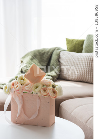 Ranunculus Bouquet with Gift Bag and Envelope in Cozy Living Room Ranunculus Bouquet with Gift Bag and Envelope in Cozy Living Room 139396958