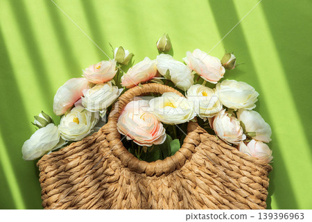 Straw Handbag with Ranunculus Flowers on Green Background Straw Handbag with Ranunculus Flowers on Green Background 139396963