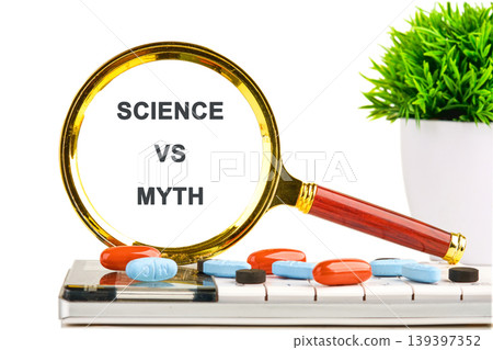 A magnifying glass with SCIENCE VS MYTH displayed in its lens. Several colorful medicine pills are scattered on a white computer keyboard. A small green plant sits nearby A magnifying glass with SCIENCE VS MYTH displayed in its lens. Several colorful medicine pills are scattered on a white computer keyboard. A small green plant sits nearby 139397352