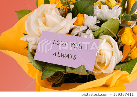 Beautiful white roses and yellow flowers are arranged in a bright yellow wrap Beautiful white roses and yellow flowers are arranged in a bright yellow wrap 139397411
